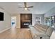 Open concept living room, fireplace, hardwood floors and tv at 1425 Monte Lake Dr, Valrico, FL 33596