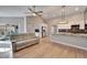 Spacious open concept living room/kitchen with ceiling fan, hardwood floors, modern lighting, fireplace and tv at 1425 Monte Lake Dr, Valrico, FL 33596