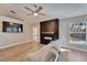 Cozy living room with hardwood floors, ceiling fan, tv and electric fireplace at 1425 Monte Lake Dr, Valrico, FL 33596