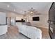 Open concept living room/kitchen with modern fireplace, hardwood floors and modern lighting at 1425 Monte Lake Dr, Valrico, FL 33596