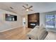 Open concept living room, hardwood floors, ceiling fan, tv and fireplace at 1425 Monte Lake Dr, Valrico, FL 33596