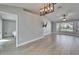 Open-concept living room features wood floors, a vaulted ceiling, and bright bay windows at 1425 Monte Lake Dr, Valrico, FL 33596