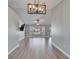 Bright living room features wood floors, modern lighting, and bay windows offering ample natural light at 1425 Monte Lake Dr, Valrico, FL 33596