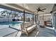 Outdoor seating area with view of pool, mini refrigerator, ceiling fan and outdoor barbecue at 1425 Monte Lake Dr, Valrico, FL 33596