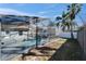 Enjoy a screened-in pool in this home's backyard, with palm trees enhancing the view at 1425 Monte Lake Dr, Valrico, FL 33596