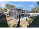 Screened-in backyard swimming pool with pool deck and outdoor kitchen with barbecue grill at 1425 Monte Lake Dr, Valrico, FL 33596