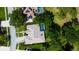 Aerial view of home featuring screen enclosed pool, lush backyard, and manicured landscaping at 16307 Colwood Dr, Odessa, FL 33556