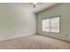 Bedroom with plush carpet, neutral walls, and a window with a view at 16307 Colwood Dr, Odessa, FL 33556