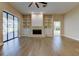 Spacious living room with fireplace, built-in shelving, and sliding glass doors at 16307 Colwood Dr, Odessa, FL 33556