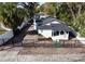 An elevated view showcases the home and the brick paved driveway and fencing surrounding the property at 1706 E Annie St, Tampa, FL 33612