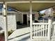 Comfortable porch with stone facade, ceiling fan, and cozy seating arrangement at 1706 E Annie St, Tampa, FL 33612