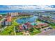 Aerial shot of the waterfront community showcasing a pool, putting green, shuffleboard, clubhouse, and residential buildings at 19029 Us Highway 19 N # 17A, Clearwater, FL 33764
