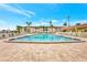 Stunning community pool with ample lounge chairs, set against a beautiful building and tropical palm trees at 19029 Us Highway 19 N # 17A, Clearwater, FL 33764