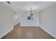 Cozy dining room with hanging chandelier and laminate flooring throughout at 19029 Us Highway 19 N # 17A, Clearwater, FL 33764