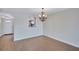 Dining room features pass-through to the kitchen, chandelier, and laminate flooring throughout at 19029 Us Highway 19 N # 17A, Clearwater, FL 33764