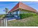 Charming waterfront home with a red tile roof, patio, and lush landscaping at 19029 Us Highway 19 N # 17A, Clearwater, FL 33764