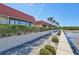 Waterfront condo featuring lush landscaping, windows, and red tile roofs at 19029 Us Highway 19 N # 17A, Clearwater, FL 33764