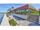 Waterfront complex featuring lush landscaping, water views, and a charming bench at 19029 Us Highway 19 N # 17A, Clearwater, FL 33764