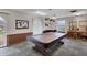 Well-lit game room featuring a covered pool table, comfortable seating, and decorative accents for leisure and entertainment at 19029 Us Highway 19 N # 17A, Clearwater, FL 33764