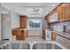 Kitchen area with wood cabinetry, stainless steel appliances, white countertops and backsplash, sink in foreground at 19029 Us Highway 19 N # 17A, Clearwater, FL 33764