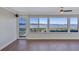 Living room featuring wood floors, a large window with a view of the water and waterfront patio at 19029 Us Highway 19 N # 17A, Clearwater, FL 33764