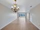 Bright living room with large window overlooking the lake, laminate flooring and hanging chandelier at 19029 Us Highway 19 N # 17A, Clearwater, FL 33764