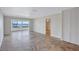 Spacious living room with large window overlooking the lake, featuring tile flooring and a ceiling fan at 19029 Us Highway 19 N # 17A, Clearwater, FL 33764