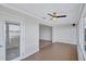 Bright living room featuring wood floors, ceiling fan, neutral walls, and sunroom access overlooking the water at 19029 Us Highway 19 N # 17A, Clearwater, FL 33764