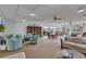 Inviting lounge area with comfortable seating, a well-stocked bookshelf, and views of the outdoor pool area at 19029 Us Highway 19 N # 17A, Clearwater, FL 33764