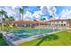 Inviting shuffleboard court surrounded by lush landscaping, palm trees, and comfortable seating in a well-maintained community space at 19029 Us Highway 19 N # 17A, Clearwater, FL 33764