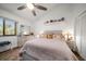 Bright bedroom featuring a large window, a ceiling fan, and a light colored dresser at 19941 Gulf Blvd # 105, Indian Rocks Beach, FL 33785