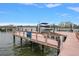 Waterfront property featuring a private boat lift and dock with scenic views of the surrounding harbor at 19941 Gulf Blvd # 105, Indian Rocks Beach, FL 33785