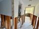 Hallway with exposed studs, tile flooring and a utility closet is visible at 200 Country Club Dr # 1001, Largo, FL 33771