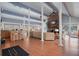 Open-concept living room with hardwood floors, kitchen bar, and fireplace at 200 Country Club Dr # 1001, Largo, FL 33771