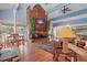 Inviting living room with hardwood floors, fireplace, and dining area near large windows at 200 Country Club Dr # 1001, Largo, FL 33771
