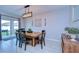 Charming dining area with a wooden table, black chairs, stylish light fixture, and sliding door access to the patio at 22167 Tucana Way, Land O Lakes, FL 34637