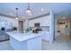 Modern kitchen with white cabinetry, quartz countertops, stainless steel appliances, and a large center island at 22167 Tucana Way, Land O Lakes, FL 34637