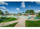 Community pool features lounge chairs, tables and lush landscaping at 244 115Th N Ave # 3, St Petersburg, FL 33716