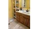Bathroom featuring wooden vanity with sink and storage, and a scale at 2510 Cypress Bend E Dr, Clearwater, FL 33761