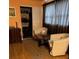 Cozy bedroom with two chairs and a closet with sliding doors at 2510 Cypress Bend E Dr, Clearwater, FL 33761