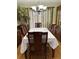 Traditional dining room with a formal table, chandelier, and elegant decor at 2510 Cypress Bend E Dr, Clearwater, FL 33761