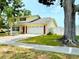 Charming home featuring a two-car garage, well-maintained lawn, and mature trees, creating a welcoming curb appeal at 2510 Cypress Bend E Dr, Clearwater, FL 33761
