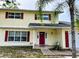 Attractive two-story home with a well-manicured lawn and eye-catching red shutters for added curb appeal at 2510 Cypress Bend E Dr, Clearwater, FL 33761