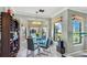 Dining area with a glass table, modern lighting, and large windows at 2773 Via Cipriani # 1330B, Clearwater, FL 33764