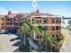 Beautiful condo complex exterior with mature palm trees, vibrant colors and scenic location in Clearwater, FL at 2773 Via Cipriani # 1330B, Clearwater, FL 33764