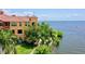 Waterfront condo building with lush landscaping, private patios, and bay views at 2773 Via Cipriani # 1330B, Clearwater, FL 33764