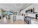 Open-concept kitchen with modern appliances flowing into the living area, perfect for entertaining at 2773 Via Cipriani # 1330B, Clearwater, FL 33764