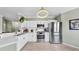 Modern kitchen with stainless steel appliances, white cabinets, and a functional layout for cooking at 2773 Via Cipriani # 1330B, Clearwater, FL 33764