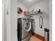 Efficient laundry room equipped with modern washer and dryer units, plus practical storage shelves at 2773 Via Cipriani # 1330B, Clearwater, FL 33764