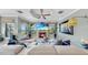 Spacious living room features a ceiling fan, fireplace, large windows and a large tv at 2773 Via Cipriani # 1330B, Clearwater, FL 33764